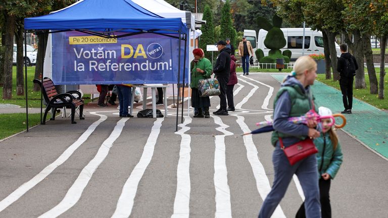 People gather near a tent set up in a street to inform of Moldova's upcoming referendum on future European Union membership and a presidential election in Chisinau, Moldova October 15, 2024. REUTERS/Vladislav Culiomza
