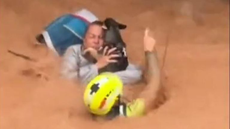 A woman and her pet were airlifted to safety in Valencia, after torrential rain caused deadly floods in parts of Spain. 