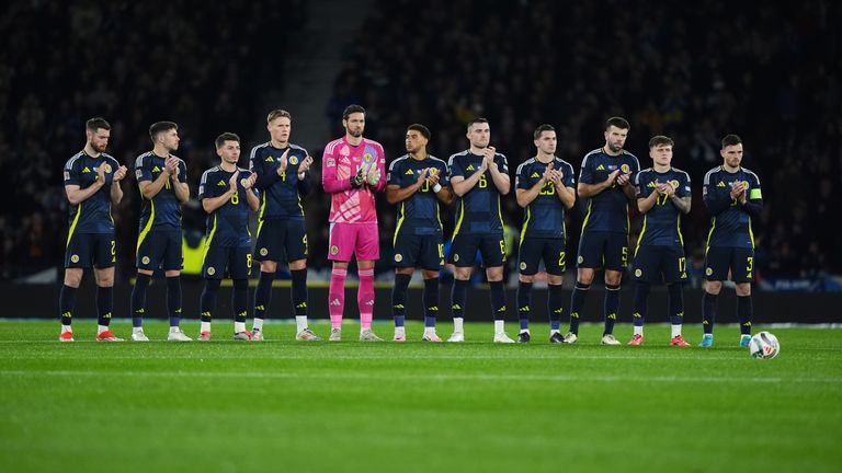 Scotland players during a moments applause in memory of Alex Salmond, ahead of the UEFA Nations League Group A1 match at Hampden Park, Glasgow. Picture date: Tuesday October 15, 2024.