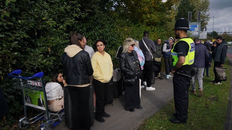 Passengers wait to board Birmingham Airport after it was evacuated following a security alert. Photo: PA