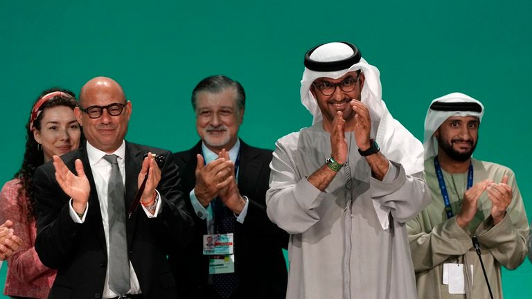 United Nations Climate Chief Simon Stiell, front left, and COP28 President Sultan al-Jaber clap at the end of the COP28 U.N. Climate Summit, Wednesday, Dec. 13, 2023, in Dubai, United Arab Emirates. (AP Photo/Kamran Jebreili)