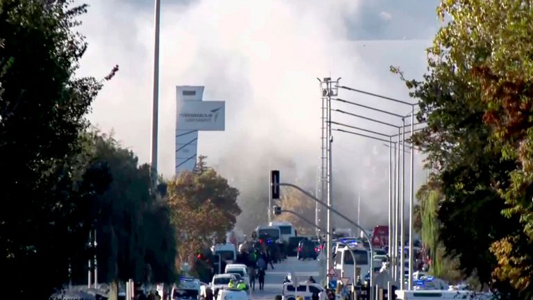 Smoke remergency ises as emergency rescue teams and police officers attend outside Turkish Aerospace Industries Inc. on the outskirts of Ankara, Turkey, Wednesday, Oct. 23, 2024. (IHA via AP)