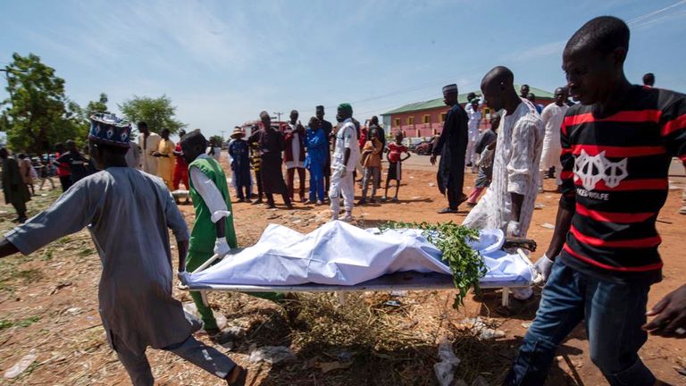 People carry the body of a victim of a tanker explosion for funeral in Majiya town, Nigeria, Wednesday, Oct. 16, 2024. (AP Photo/Sani Maikatanga)