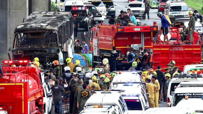 Rescue workers extinguish a burning bus carrying teachers and students from Wat Khao Phraya school.
Pic: Reuters