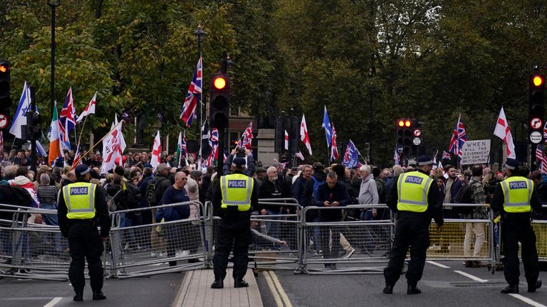 Far right pro-UK rally protesters endorsed by Tommy Robinson, demonstrate behind a police line in London on Saturday. Pic: AP