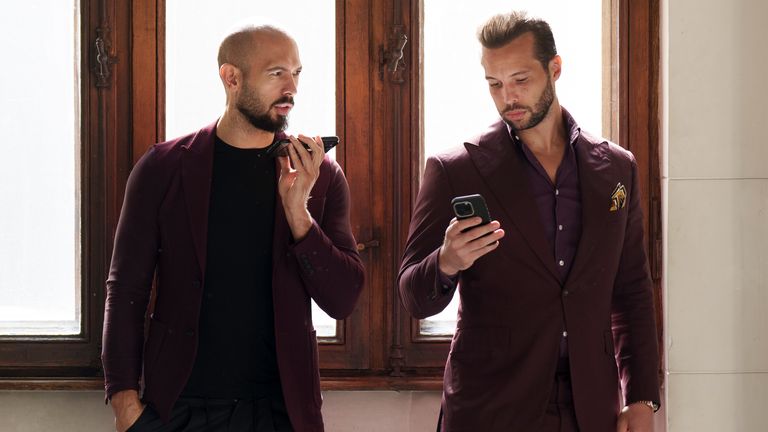 Andrew Tate and his brother Tristan wait at the Court of Appeals building in Bucharest, Romania.
Pic: AP