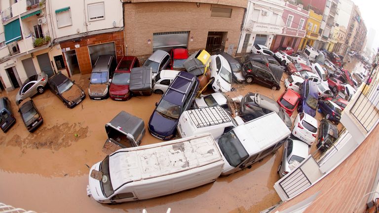 Cars are photographed piled up after being swept away by floods in Valencia.
Pic: AP