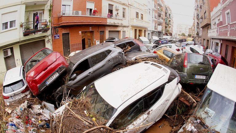 Cars are photographed piled up after being swept away by floods in Valencia, Spain.
Pic: AP