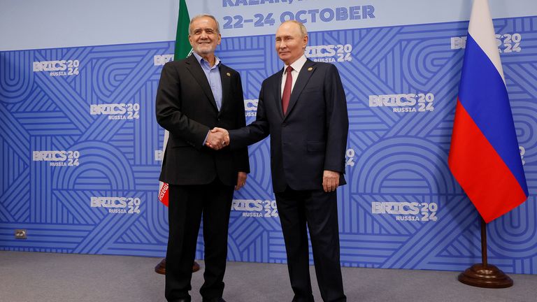 Vladimir Putin shakes hands with Iranian President Masoud Pezeshkian during a meeting on the sidelines of the BRICS summit in Kazan.
Pic: Reuters