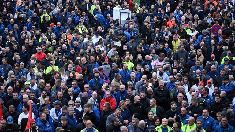 Workers of Europe's largest carmaker Volkswagen AG gather during a briefing of the Works Council about VW's plans to close down three plants and lay off thousands of employees at the VW headquarters in Wolfsburg, Germany