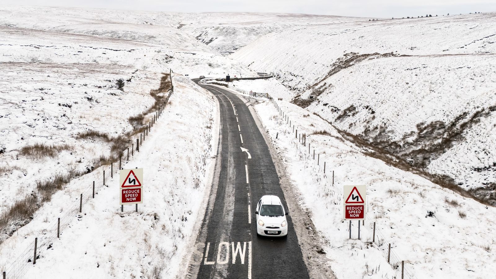 Weather latest: New snow and ice alerts issued; travel disruption on roads and trains; schools closed