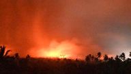 In this photo made available by Indonesia's Center for Volcanology and Geological Disaster Mitigation Agency (PVMBG) of the Ministry of Energy and Mineral Resources, the sky glows from the eruption of Mount Lewotobi Laki-Laki early Monday, Nov. 4, 2024, in East Flores, Indonesia. (PVMBG via AP)