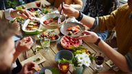 People sitting at dining table and eating