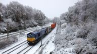 A freight train passes along snow covered track in Newcastle-Under-Lyme, Britain, November 19, 2024. REUTERS/Phil Noble