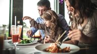 A file picture of a family eating in a restaurant. Pic: iStock