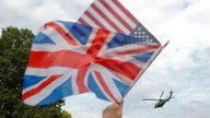 A woman waves British and U.S. flags as she watches Marine One helicopter, with President Donald Trump and first lady Melania Trump aboard, liftoff from Winfield House, residence of the US Ambassador, before boarding Marine One helicopter for the flight to nearby Blenheim Palace, Thursday, July 12, 2018 in London. (AP Photo/Pablo Martinez Monsivais)