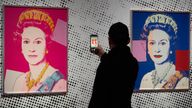 A man takes an image of a screen print depicting Queen Elizabeth II, one in a series of sixteen prints of four queens titled Reigning Queens, 1985, by Andy Warhol at museum Paleis Het Loo in Apeldoorn, Netherlands, Wednesday, Oct. 9, 2024, similar to a Warhol work stolen from a gallery in Oisterwijk, Netherlands, early Friday, Nov. 1, 2024. (AP Photo/Peter Dejong)