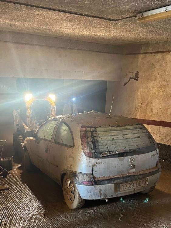 Photos from Adam Parsons in Catarroja, Spain at an underground car park where people are cleaning up after flooding
