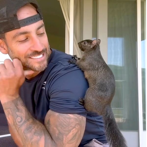 Mark Longo with his pet squirrel Peanut. Picture: AP