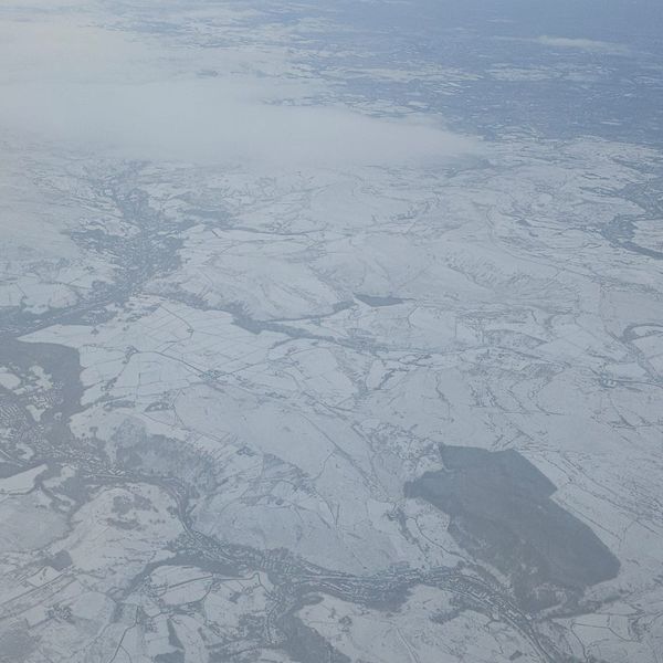 The snow-covered countryside as seen on a flight from Leeds to Belfast