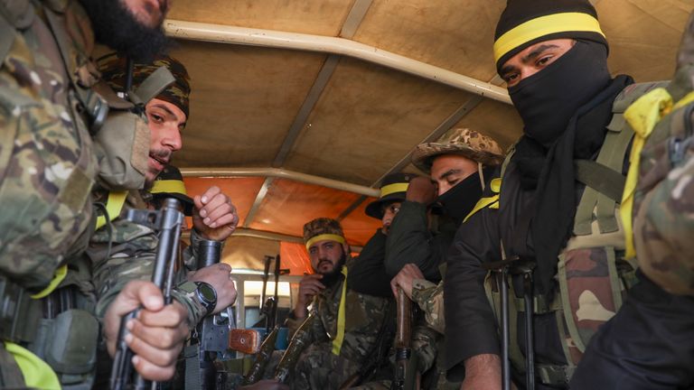 Syrian opposition fighters ride in a truck as they enter the village of Anjara, western outskirts of Aleppo, Syria, Thursday Nov. 28, 2024, part of  their major offensive on government-controlled areas in the country's northwestern Syria. (AP Photo/Omar Albam)