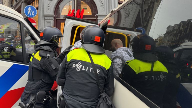 Dutch police detain a pro-Palestine protester during the banned demonstration.
Pic: Reuters