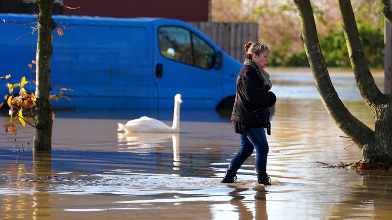 A person walks through floodwater at the Billing Aquadrome in Northamptonshire. Storm Bert will continue to bring disruption into Monday after torrential downpours caused "devastating" flooding over the weekend. Picture date: Monday November 25, 2024. PA Photo. See PA story WEATHER Bert. Photo credit should read: Jordan Pettitt/PA Wire