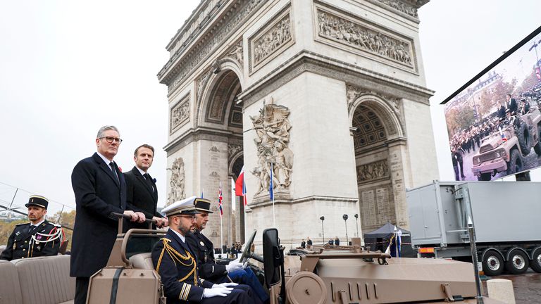 Emmanuel Macron and  Keir Starmer pass the Arc de Triomphe.
Pic: AP