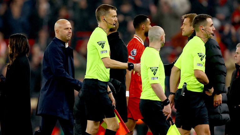 Arne Slot looks on as referee David Coote (Rt) leaves the pitch with the assistant referees after the match.
Pic:Reuters