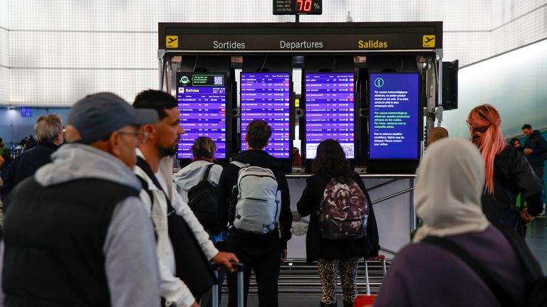 People check the departure board at Barcelona-El Prat airport as flights are diverted due to the weather.
Pic: Europa Press/AP