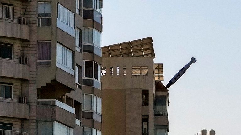 A bomb dropped from an Israeli jet prepares to hit a building in Tayouneh, Beirut, Lebanon, Friday, Nov. 15, 2024. (AP Photo/Hassan Ammar)