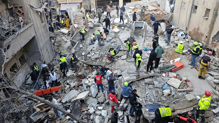 Rescuers search for victims at the site of an Israeli airstrike that targeted a building in Beirut, Lebanon, Tuesday, Nov. 26, 2024. (AP Photo/Hassan Ammar)