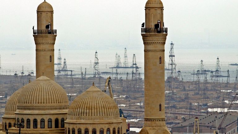 FILE - This file photo shows the Bibi Heybat Mosque with oil derricks in the background in Baku, Azerbaijan, on March 7, 2019. (AP Photo/Mikhail Metzel, File)