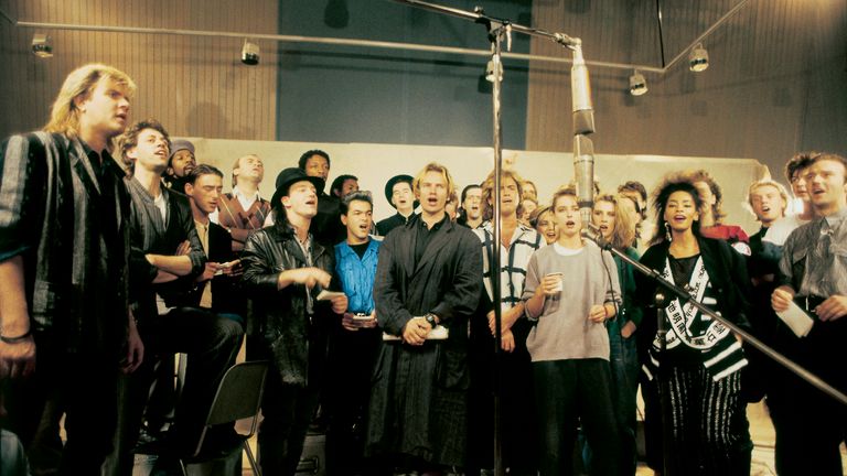 Undated handout photo issued by Band Aid of Sir Bob Geldof (second left), along with other artists recording the first ever Band Aid single, Do They Know It's Christmas. A new 40th anniversary mix of Band Aid's Do They Know It's Christmas? will see the young and old voices of the charity single's artists come together to create an "ultimate" version. Issue date: Wednesday November 13, 2024. PA Photo. Do They Know It's Christmas? - 2024 Ultimate Mix will premiere on UK breakfast radio and streaming on November 25, the 40th anniversary of the recording of the original song, and will be released physically on the Band Aid Compilation on November 29 on CD and vinyl. The new version of the song will feature voices from three previous editions of the song, Band Aid (1984), Band Aid 20 (2004) and Band Aid 30 (2014), including Harry Styles, George Michael and Chris Martin, and will see young and old voices of the likes of Bono singing together. See PA story SHOWBIZ BandAid . Photo credit should read: Brian Aris/Band Aid/PA Wire NOTE TO EDITORS: This handout photo may only be used in for editorial reporting purposes for the contemporaneous illustration of events, things or the people in the image or facts mentioned in the caption. Reuse of the picture may require further permission from the copyright holder.