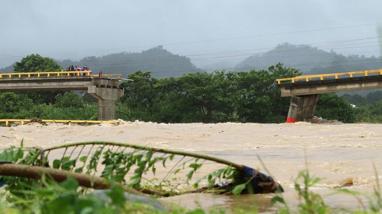 A bridge partially collapsed after the Cangrejal River overflowed its banks due to heavy rain brought by Tropical Storm Sara. Pic: Reuters