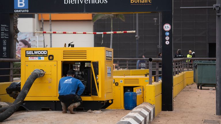 A pump to remove water from the car park is seen at the site. Pic: AP