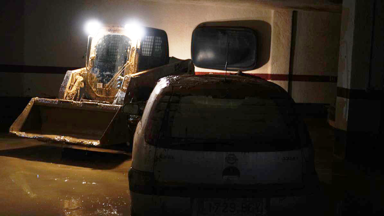 Photos from Adam Parsons in Catarroja, Spain at an underground car park where people are cleaning up after flooding
