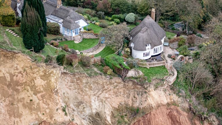 This shows the cottage teetering off the edge of the partially collapsed cliff. Pic: PA