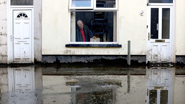 Brian Preece, 77, poses for a photograph at his home on a mud-covered street, in the aftermath of Storm Bert, in Cwmtillery, South Wales, Britain, November 25, 2024. REUTERS/Hollie Adams