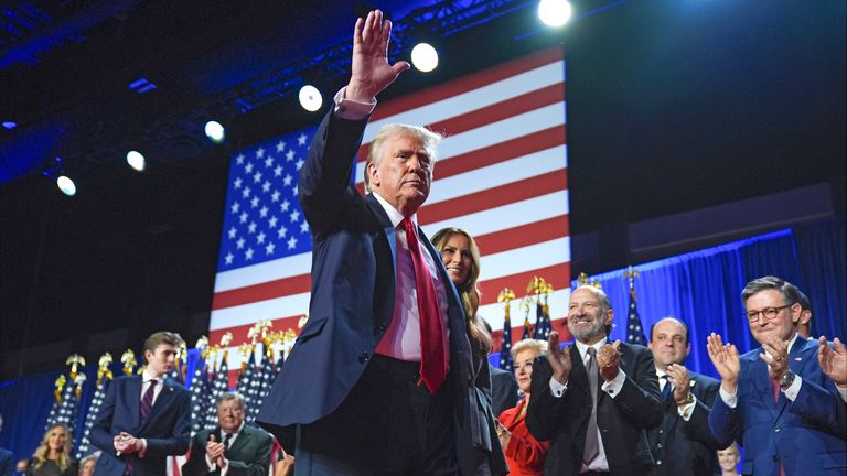 Republican presidential nominee former President Donald Trump waves as he walks with former first lady Melania Trump at an election night watch party at the Palm Beach Convention Center, Wednesday, Nov. 6, 2024, in West Palm Beach, Fla. (AP Photo/Evan Vucci)