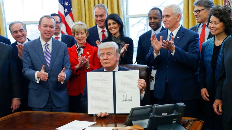 Congratulating Donald Trump's 2017 executive order on 'reorganising the executive branch' in the Oval Office. Pic: AP