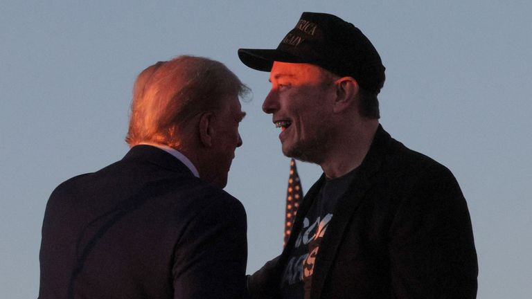 Tesla CEO and X owner Elon Musk stands with Republican presidential nominee former U.S. president Donald Trump during a campaign rally, on the day Trump returns to the site of the July assassination attempt against him, in Butler, Pennsylvania, U.S., October 5, 2024. REUTERS/Brian Snyder