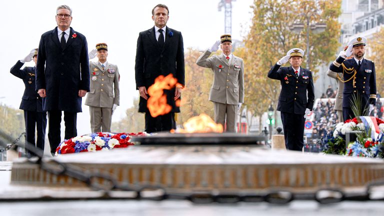 Emmanuel Macron and Britain's Prime Minister Keir Starmer stand at attention before the Tomb of the Unknown Soldier at Place de l'Etoile, in Paris, on November 11, 2024, as part of the commemorations marking the 106th anniversary of the November 11, 1918, Armistice, ending World War I.   Ludovic Marin/Pool via REUTERS.