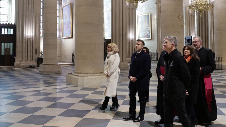 epa11747155 French President Emmanuel Macron (C) and First Lady Brigitte Macron (L) during a visit to Notre-Dame de Paris cathedral in Paris, France, 29 November 2024. French President Macron is visiting the cathedral's construction site on 29 November, to thank the donors and people who worked to rebuild the monument after it was severely damaged in a fire that broke out on 15 April 2019. The Paris Cathedral will be officially inaugurated after nearly six years of renovation work on 07 December