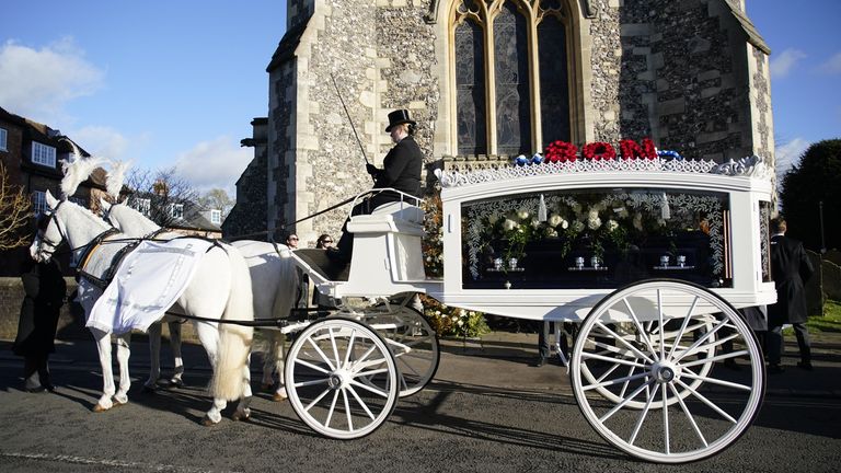 A horse-drawn carriage carrying the coffin of Liam Payne arrives for the funeral service.
Pic: PA