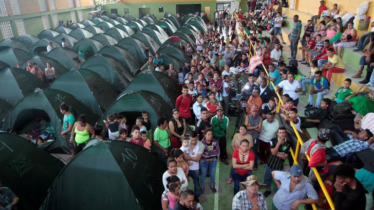 People are pictured at a tent camp at the municipal coliseum after the Colombian government ordered the evacuation of residents living along the Cauca river, as construction problems at a hydroelectric dam prompted fears of massive flooding, in Valdivia, Colombia May 18, 2018. REUTERS/Fredy Builes
