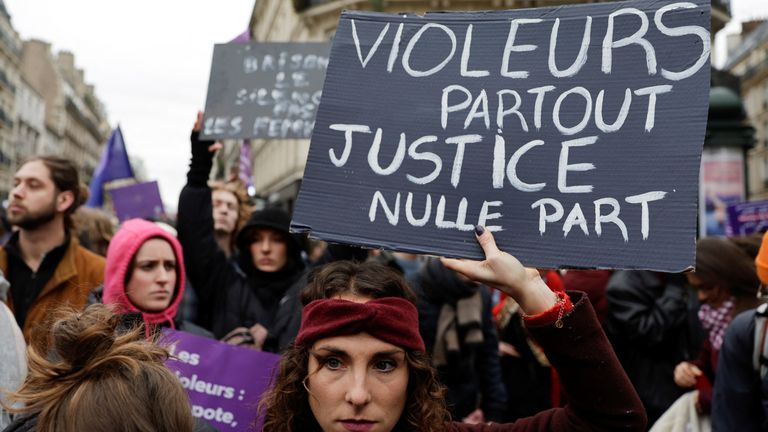 A woman holds a banner as participants attend a demonstration to protest femicide, sexual violence and all forms of gender-based violence on the occasion of the International Day for the Elimination of Violence against Women in Paris, France, November 23, 2024. The banner reads: "Rapists are everywhere, justice is nowhere". REUTERS/Abdul Saboor