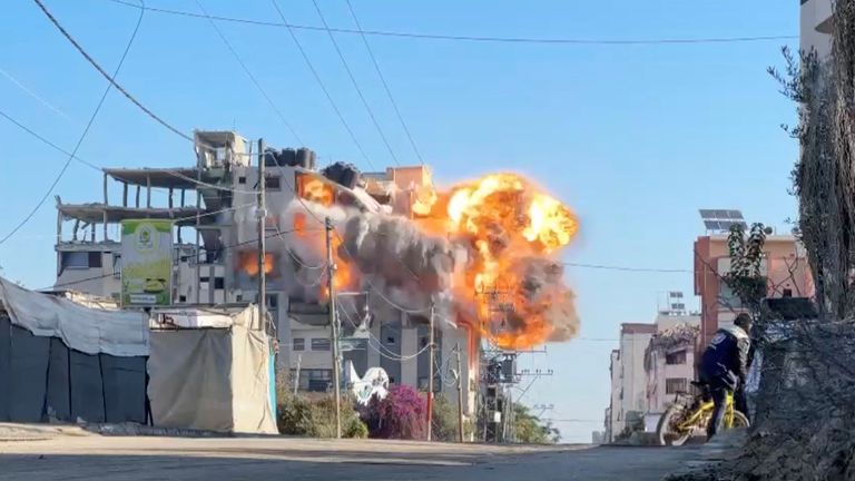 Smoke and flames rise from a residential building hit by an Israeli strike, amid the ongoing conflict between Israel and Hamas, in Nuseirat refugee camp, in the central Gaza Strip, November 28, 2024 in this screengrab taken from a video. Reuters TV/via REUTERS