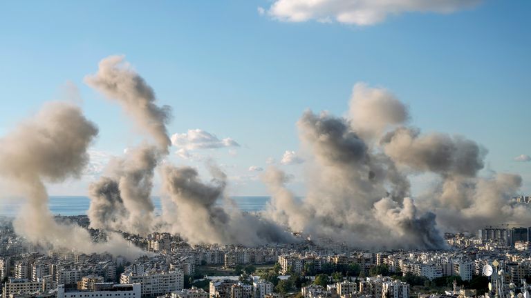 Smoke rises over Dahiyeh, Beirut, after an Israeli strike on Tuesday.
Pic: AP/Bilal Hussein