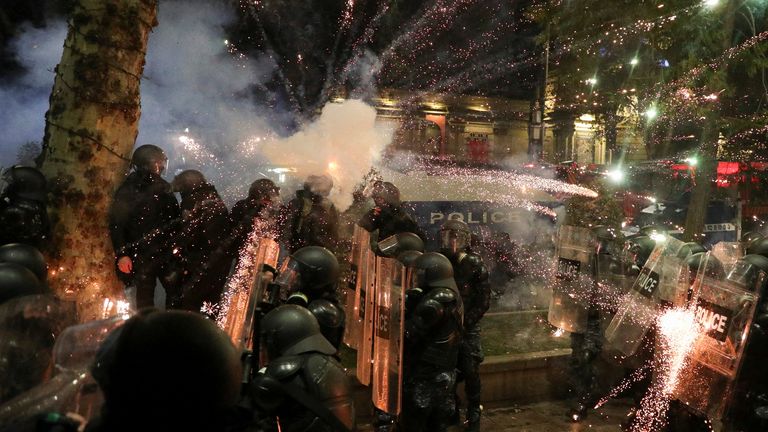 Fireworks explode as police and protesters clash in Tbilisi on Saturday. Pic: Reuters